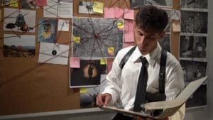 young man looking at documents in riverside county