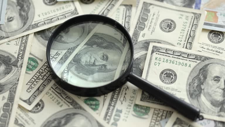 magnifying glass on money Private Detective Salary