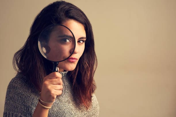 Private Investigator Santa Clarita CA looking through a magnifying glass